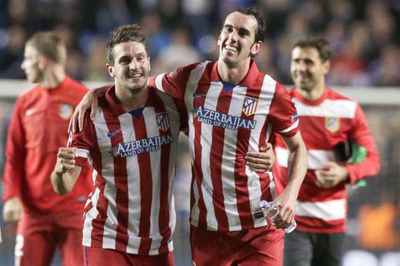 Azerbaijan have received plenty of return on their investment as Atletico Madrid's shirt sponsor with Koke, left, Diego Godin and the Spanish club enjoying success domestically and in Europe. Matt Dunham / AP