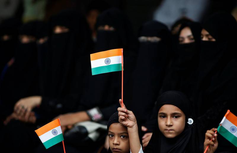 Girls hold the Indian national flags as they attend a flag hoisting ceremony in Ahmedabad. Reuters