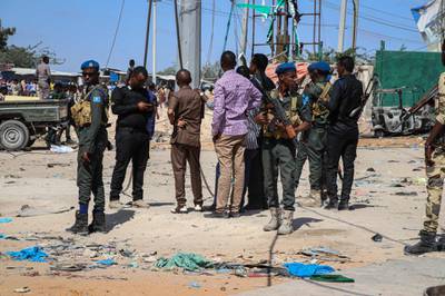 Police officers secure the area at a car bombing attack site in Mogadishu. AFP